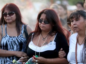 Tina Fontaine, centre, walks during a vigil honouring her daughter, Tina Fontaine, and Faron Hall at the Alexander Docks in Winnipeg, Manitoba, Tuesday, August 19, 2014.