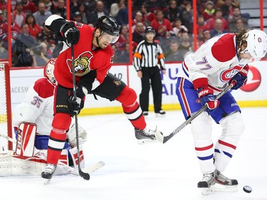 Tom Gilbert of the Montreal Canadiens blocks the shot as Milan Michalek of the Ottawa Senators waits to tip the puck during first period NHL action.