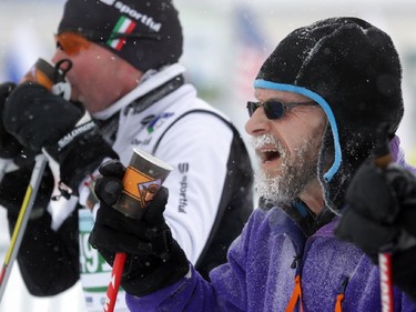 Two skiers drink some water during the Gatineau Loppet in Gatineau, Saturday, February 14, 2015. Competitors braved falling snow plus bone-chilling temperatures to participate in today's event, which started at 9am.