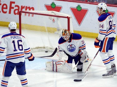 Edmonton Oilers goaltender Viktor Fasth, centre, hangs his head as Teddy Purcell, left, and Oscar Klefborn look on after a goal by the Ottawa Senators during second period NHL hockey action in Ottawa on Saturday, Feb. 14, 2015.