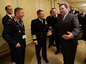 Defence Minister Jason Kenney, right, shares a laugh with Admiral William Gortney, NORAD and U.S. Northern Command, middle, and Commander Canadian Joint Operations Command Lieutenant-General Jonathan Vance, left, during the Conference of Defence Associations Institute conference on security and defence at the Chateau Laurier in Ottawa on Thursday, February 19, 2015.