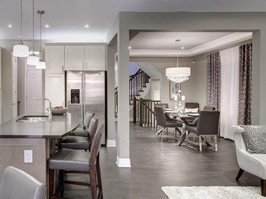 The formal dining room, great room, kitchen and eating area are studded with pot lights and accented by high-end glass and chrome fixtures.