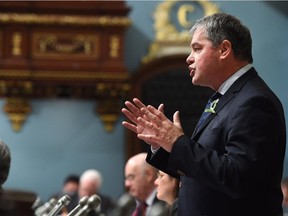 Quebec Education Minister Yves Bolduc responds to Opposition questions Tuesday, Feb. 17, 2015 at the legislature in Quebec City. Bolduc defended a school decision to strip search a 15-year-old girl.