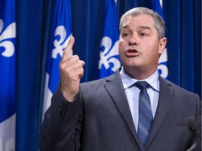 Quebec Education Minister Yves Bolduc reacts in news conference at the Quebec legislature in Quebec City on Tuesday, July 8, 2014.