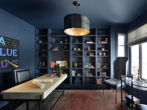 A den off the main hall makes a statement in deep blue in the Douglas, one of two single-family home models that recently opened at The Orchard.