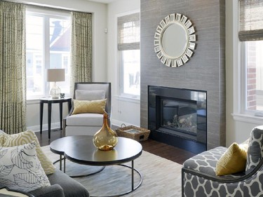 A starburst mirror accents the wall above the gas fireplace in the Palmer living room.