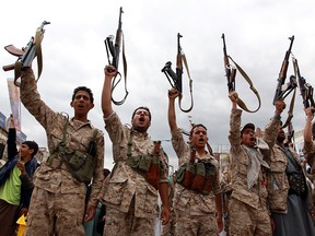 Yemeni men wearing military fatigue and loyal to the Huthi movement brandish their weapons on March 26, 2015 during a gathering in Sanaa to show support the Shiite Huthi militia and against the Saudi-led intervention in the country. Warplanes from a Saudi-led Arab coalition bombed Huthi rebels in support of Yemen's embattled president, as regional rival Iran warned the intervention was a "dangerous" move. AFP PHOTO / MOHAMMED HUWAIS        (Photo credit should read MOHAMMED HUWAIS/AFP/Getty Images)