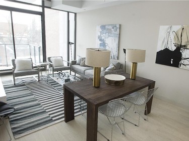 At 922 square feet, Loft 7 is the largest of the four models. Contemporary reigns in the living area with metal basket dining chairs, a gleaming white laminate credenza, and low-slung steel and fabric easy chairs.