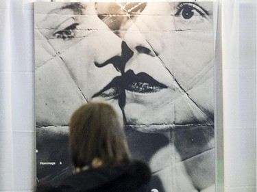 A customer looks at a photo by American photographer Man Ray at the Ottawa Antique and Vintage Market at the Carleton University Fieldhouse.