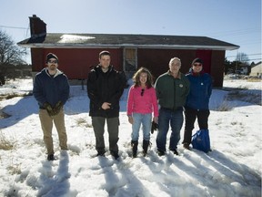 Tony Law; Tristan Maack; Sue Romaniuk; Brian Law and Craig MacAulay are concerned Bells Corners residents in front of 530 Moodie Drive an old derelict home has generated a lot of talk on a Facebook page. Bells Corners residents want this thing torn down once and for all.  (Pat McGrath / Ottawa Citizen)