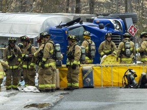 Emergency crews clean up after a fuel truck turned over and spilt it's contents at Alti Place near Moodie Dr on Thursday. (Pat McGrath / Ottawa Citizen)