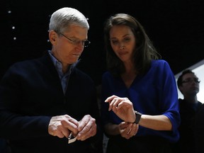 Apple CEO Tim Cook (L) speaks with model Christy Turlington Burns (R) as they appear at the Apple Watch demonstration area during an Apple special event at the Yerba Buena Center for the Arts on March 9, 2015 in San Francisco, California.