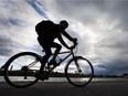 A cyclist rides along Dow's Lake under cloudy skies.  Spec Assignment  // Photo taken at 17:24 on October 8, 2014. (Wayne Cuddington/Ottawa Citizen)