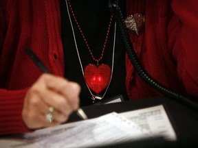 A flashing heart hangs around a volunteers neck during The University of Ottawa Heart Institute's 24th annual telethon at the Heart Institute on Sunday, March 1, 2015.