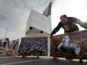 A volunteer of the non-governmental organization Handicap International places a picture, showing a cluster bomb in Lebanon, during an action supporting a cluster bomb ban on November 3, 2008 in front of the United Nations offices in Geneva.