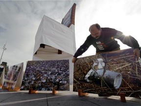 A volunteer of the non-governmental organization Handicap International places a picture, showing a cluster bomb in Lebanon, during an action supporting a cluster bomb ban on November 3, 2008 in front of the United Nations offices in Geneva.