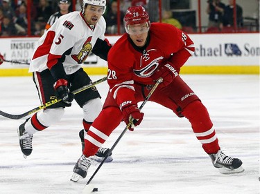 Carolina Hurricanes' Alexander Semin (28) of Russia, brings the puck up the ice after taking it away from Ottawa Senators' Cody Ceci (5) during the second period.