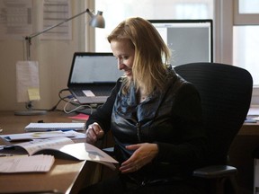 Alison Loat, Executive Director of Samara, reads through the organization's report about the state of democracy in Canada in her Toronto office  on Tuesday, March 24, 2015.