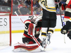 Andrew Hammond (L) of the Ottawa Senators tries to make the save as Loui Eriksson of the Boston Bruins gets in the way during second period of NHL action at Canadian Tire Centre in Ottawa, March 19, 2015.   (Jean Levac/ Ottawa Citizen)