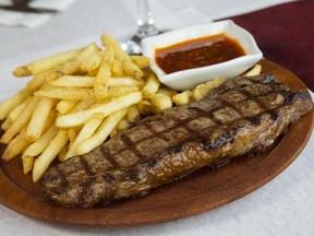 Argentine steak with chimichurri sauce from El Gusto Mazzola in Ottawa is photographed Friday March 20, 2015. (Darren Brown/Ottawa Citizen)