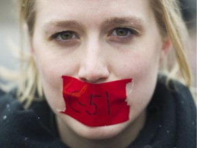 A woman protests on a national day of action against Bill C-51, the government's proposed anti-terrorism legislation, in Montreal, Saturday, March 14, 2015.