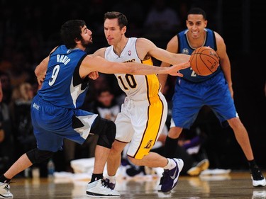 Ricky Rubio (L) of the Minnesota Timberwolves vies for the ball with Steve Nash of the Los Angeles Lakers (R) during action from their NBA game in Los Angeles, California on November 10, 2013.