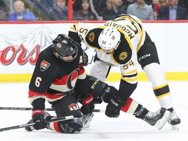 Bobby Ryan of the Ottawa Senators is tangled with Adam McQuaid of the Boston Bruins during first period NHL action.