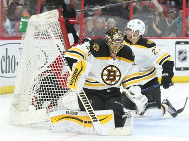 Bobby Ryan of the Ottawa Senators was pushed in the net by Dougie Hamilton, right, against Tuukka Rask and the Boston Bruins during first period NHL action.