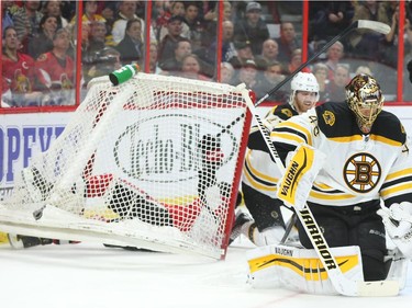 Bobby Ryan of the Ottawa Senators was pushed into the net by Dougie Hamilton, centre, against Tuukka Rask and the Boston Bruins during first period NHL action.