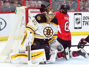 Bobby Ryan of the Ottawa Senators was pushed into the net of Tuukka Rask of the Boston Bruins by Dougie Hamilton during first period NHL action.