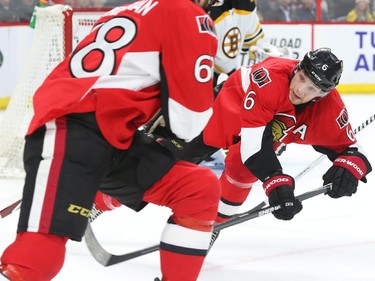 Bobby Ryan, right, and Mike Hoffman of the Ottawa Senators in action against the Boston Bruins during first period NHL action.