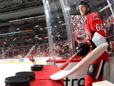 Mike Hoffman #68 of the Ottawa Senators reaches for warmup pucks with his stick prior to a game against the Boston Bruins.