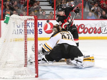 Alex Chiasson #90 of the Ottawa Senators sends the puck over the net on a scoring chance against Tuukka Rask #40 of the Boston Bruins.