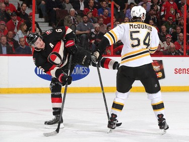 Bobby Ryan #6 of the Ottawa Senators gets tangled up with Adam McQuaid #54 of the Boston Bruins.