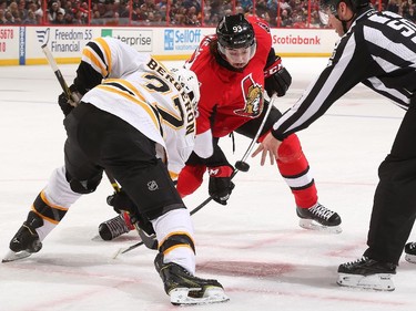 Mika Zibanejad #93 of the Ottawa Senators faces off against Patrice Bergeron #37 of the Boston Bruins.