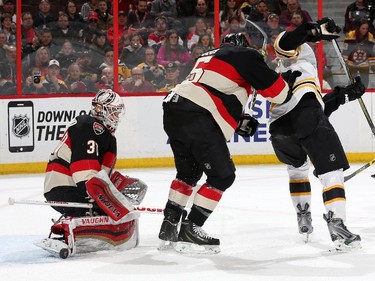 Andrew Hammond #30 of the Ottawa Senators makes a toe save against the Boston Bruins as Cody Ceci #5 of the Ottawa Senators defends the net.