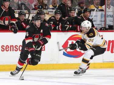 Bobby Ryan #6 of the Ottawa Senators xskates with the puck against Carl Soderberg #34 of the Boston Bruins.