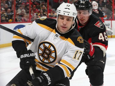 Patrick Wiercioch #46 of the Ottawa Senators skates after Milan Lucic #17 of the Boston Bruins for the puck.