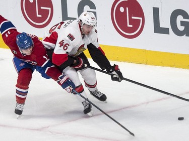 Montreal Canadiens' Brendan Gallagher reaches for the puck past Ottawa Senators' Patrick Wiercioch during second period NHL hockey action.