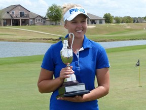 Brooke Henderson shows off the winner's trophy after winning the Suncoast Ladies Tour Winter Championship golf tournament at Eustis, Fla., on Friday, March 13, 2015.
