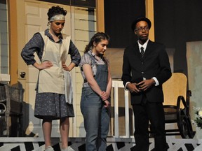 Calpurnia played by Paige Kedrosky (L), Scout Finch played by Victoria Gay (2ndFL), Reverend Sykes played by Nathan Cohen (R) during Sacred Heart Catholic High School's production of To Kill A Mockingbird.