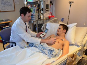 Cardiologist Dr. Benjamin Hibbert uses the Pocket Echo, a new diagnostic device, at the University of Ottawa Heart Institute on patient Justin Thornton.