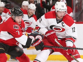 Kyle Turris #7 of the Ottawa Senators reaches with his stick to knock the puck away from Eric Staal #12 of the Carolina Hurricanes at Canadian Tire Centre on February 16, 2015.