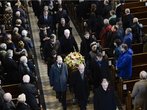 Ernest Côté's casket leaves Notre Dame Cathedral following a funeral service Saturday.