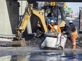 City of Ottawa road crews work to clean up a watermain break on Riverside Dr. between Tremblay Rd. and Industrial Ave. Monday March 09, 2015.