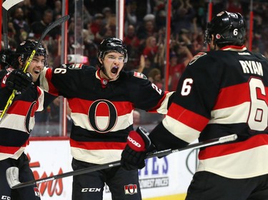 Cody Ceci (L), Matt Puempel and Bobby Ryan (R) of the Ottawa Senators celebrate Ryan's game winning goal against the Boston Bruins during third period of NHL action at Canadian Tire Centre in Ottawa, March 19, 2015.   (Jean Levac/ Ottawa Citizen)