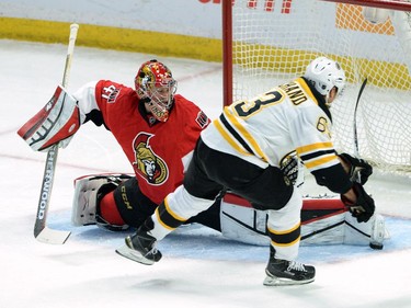 Ottawa Senators' Craig Anderson makes a pad save as Boston Bruins' Brad Marchand has a breakaway during first period NHL action.