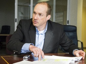 Craig Forcese, national security scholar from the University of Ottawa, speaks with Ian MacLeod in the national bureau in Ottawa Tuesday February 03, 2015. (Darren Brown/Ottawa Citizen)