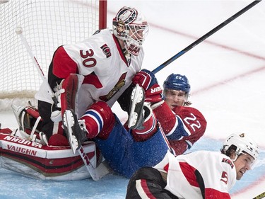 Montreal Canadiens' Dale Weise slides into Ottawa Senators goalie Andrew Hammond during first period NHL hockey action.