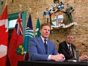 Daniel Alfredsson holds a news conference before receiving the key to the city from Deputy Mayor Bob Monette, right, outside the mayor's office.